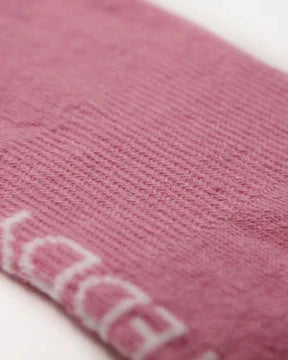 Close-up of arch support elastic in pink and yellow ribbed crew socks