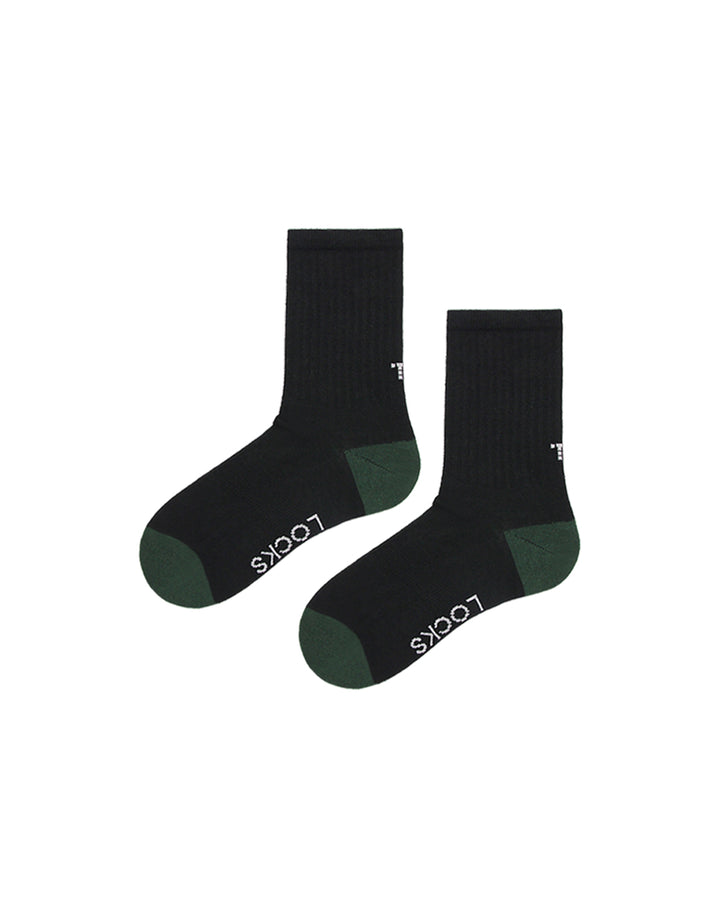 Black ribbed crew socks with evergreen heel and toe accents