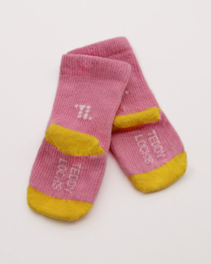 Knitting details of pink and yellow baby socks from Teddy Locks