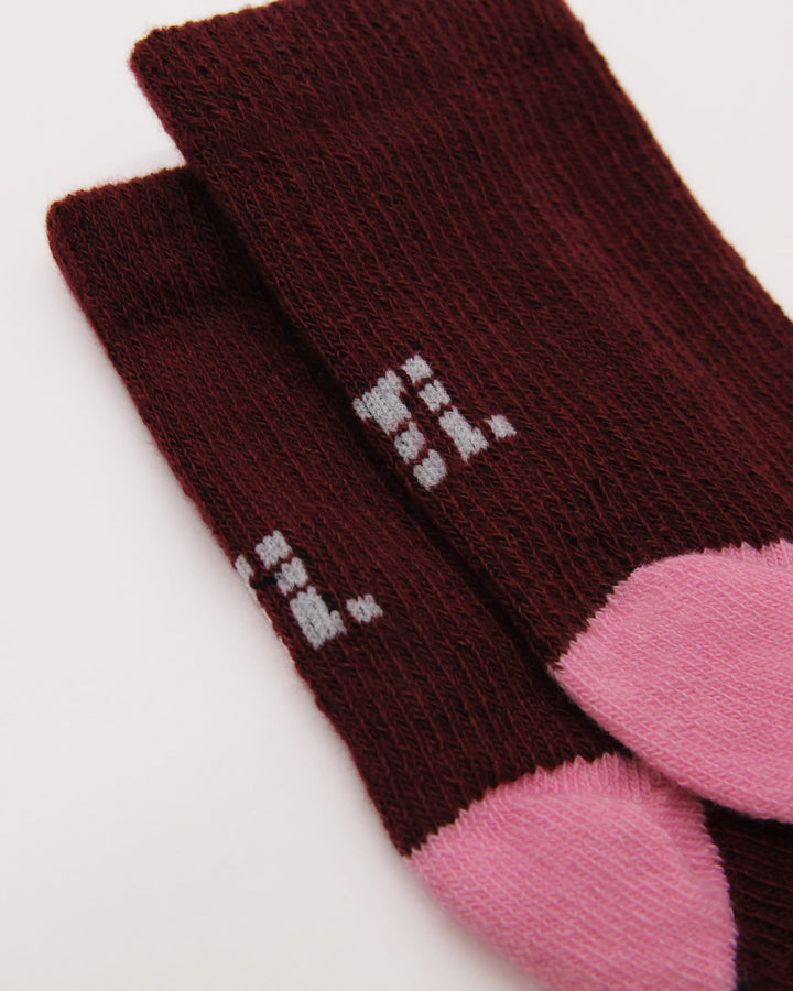 Knitting details of burgundy and pink baby socks