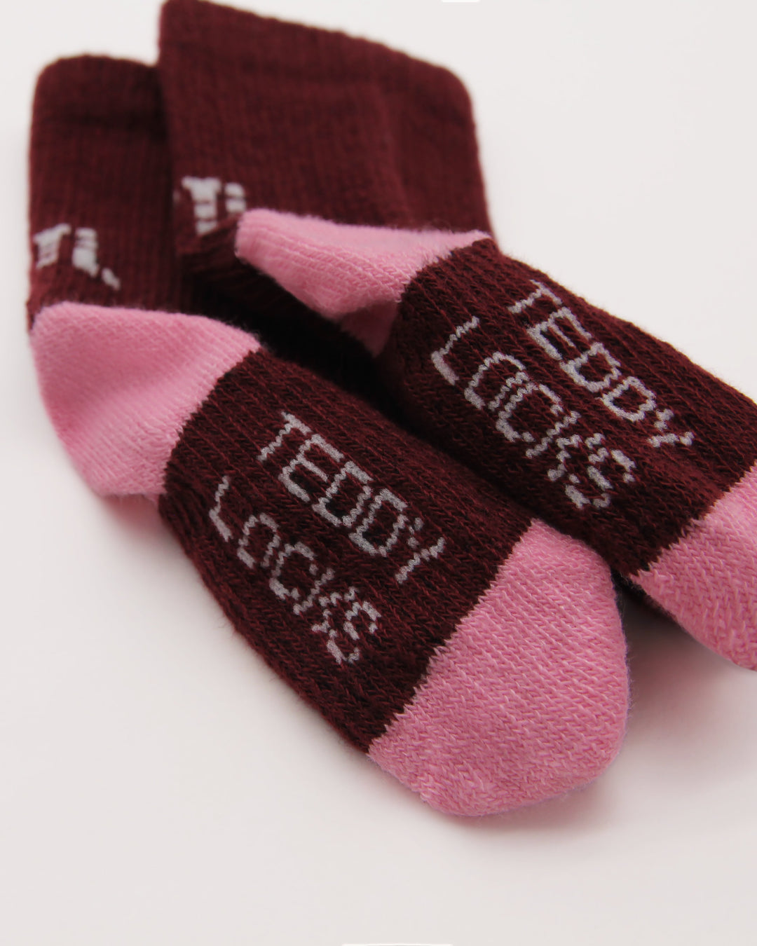 Close-up of burgundy and pink baby socks from Teddy Locks