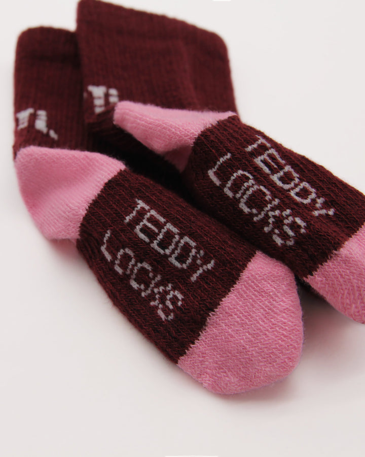 Close-up of burgundy and pink baby socks from Teddy Locks