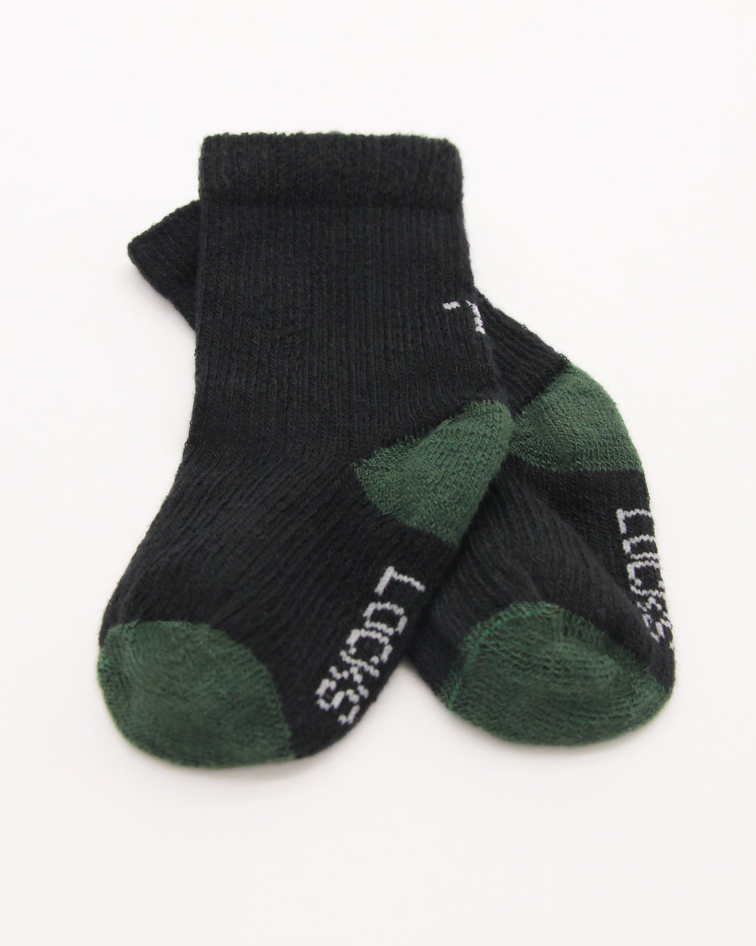 Close-up of black and green baby socks from Teddy Locks