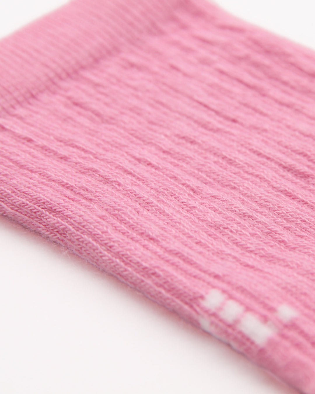 Close-up of knitted elasticated leg in pink for children