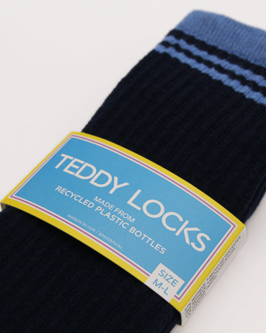Pair of Navy and blue ribbed crew socks showing Teddy Locks made from recycled plastic bottles label