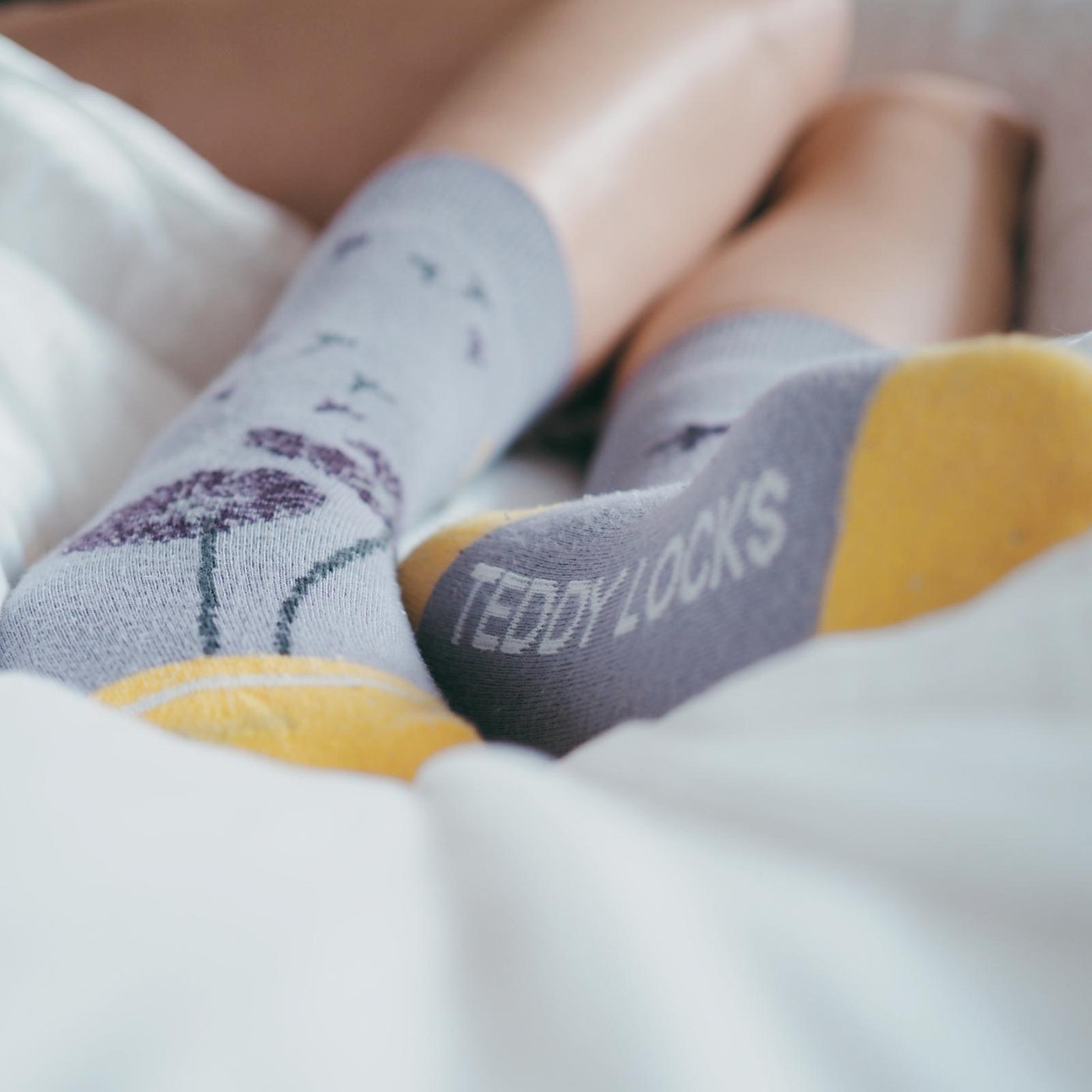 Teddy Locks sustainable socks. Light purple socks with yellow patterns. Soft socks for women.
